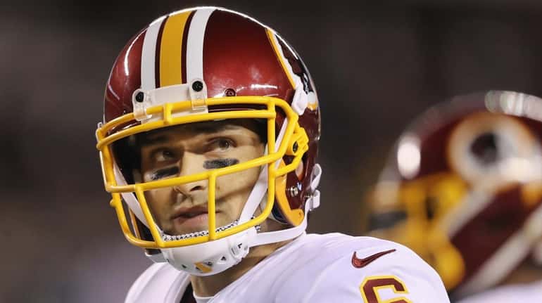Redskins quarterback Mark Sanchez looks on during a stop in play...