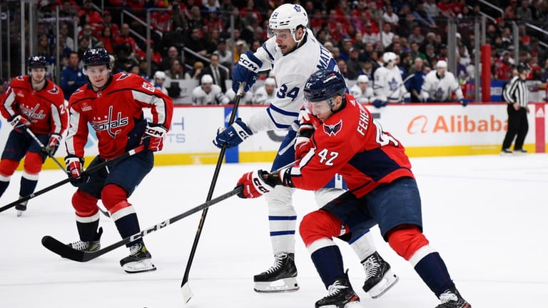 Toronto Maple Leafs center Auston Matthews (34) battles for the...