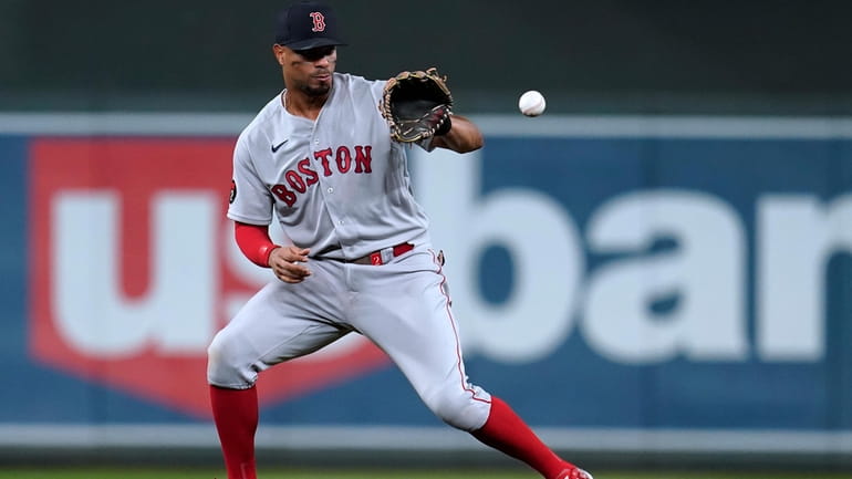 FILE - Boston Red Sox's Xander Bogaerts fields the ball...
