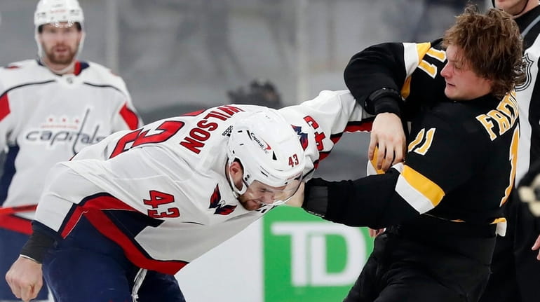 The Bruins' Trent Frederic and the Capitals' Tom Wilson fight...