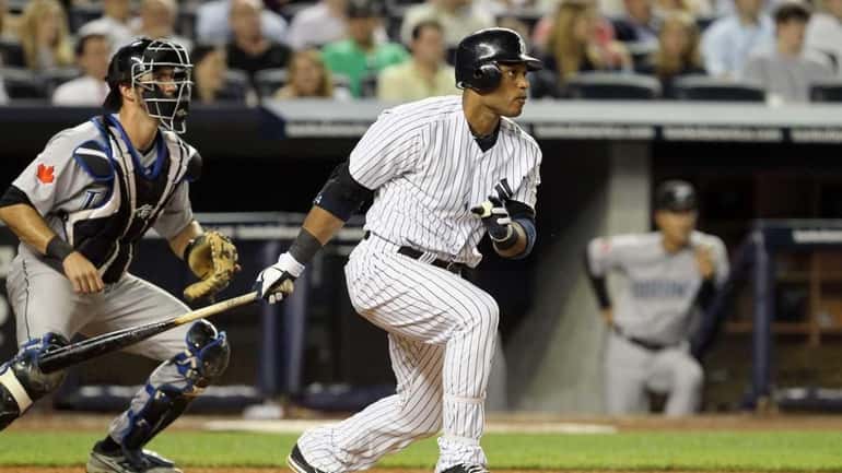 Robinson Cano of theYankees hits an eighth inning RBI double...