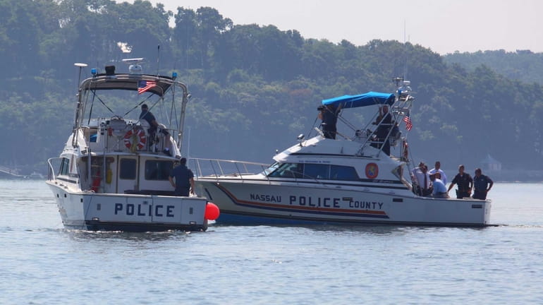Police boats search for a capsized vessel about 1/4 mile...