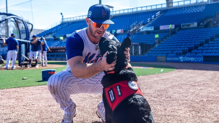 New York Mets first baseman Pete Alonso plays with Bear,...