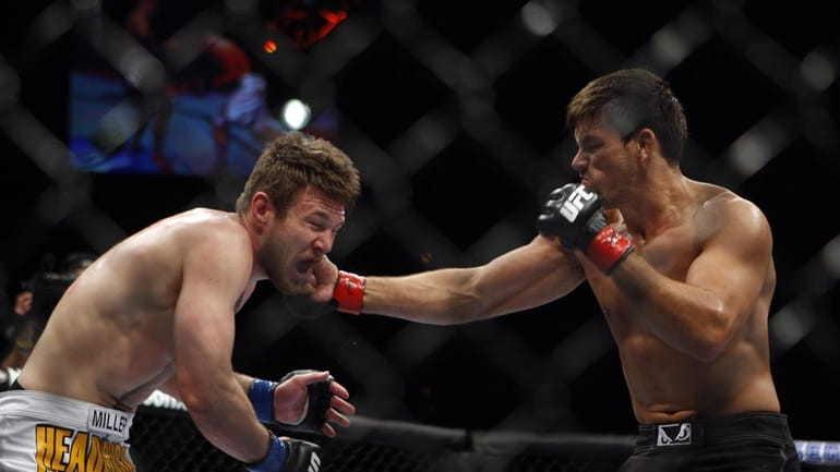 Demian Maia, right, punches Dan Miller during their mixed martial...