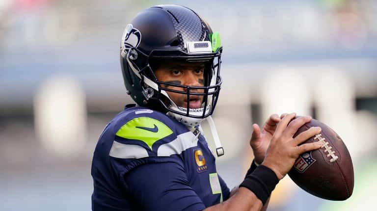 Seahawks quarterback Russell Wilson warms-up before an NFL game against...