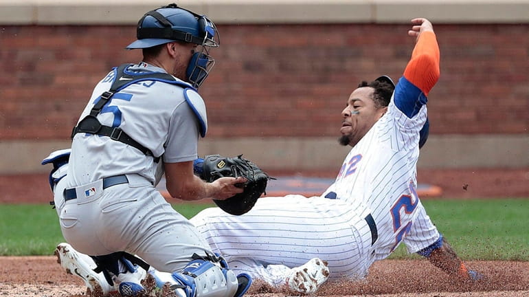 Mets first baseman Dominic Smith scores on a double to...