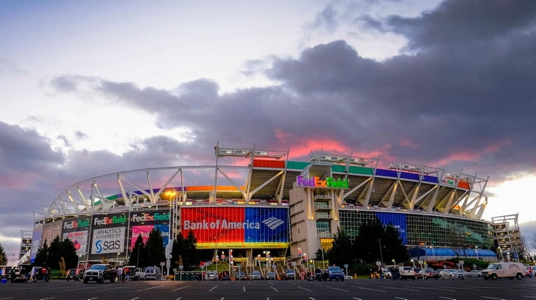 The sun sets behind FedEx Field before a game between...