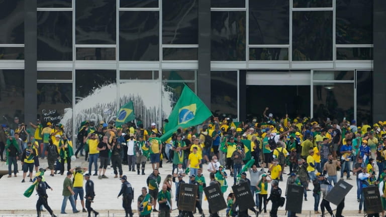 Protesters, supporters of Brazil's former President Jair Bolsonaro, storm the...