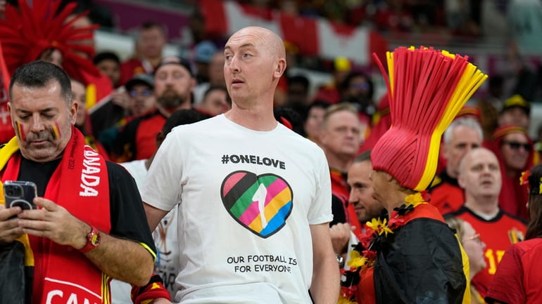 Germany's supporter wearing a rainbow jersey waits for the World...