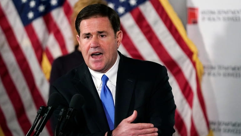 Arizona Gov. Doug Ducey answers a question during a news...