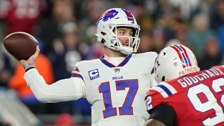 Buffalo Bills quarterback Josh Allen (17) throws under pressure from...