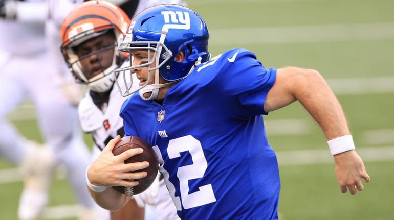 Colt McCoy #12 of the Giants carries the ball during the...