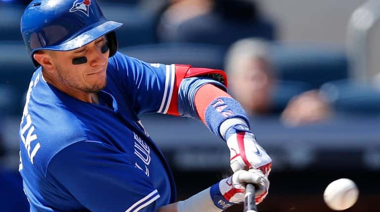 Troy Tulowitzki hits a seventh-inning single in a game against...