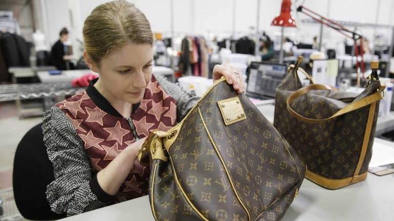 Jenna Starr inspects Louis Vuitton handbags on April 9, 2014...