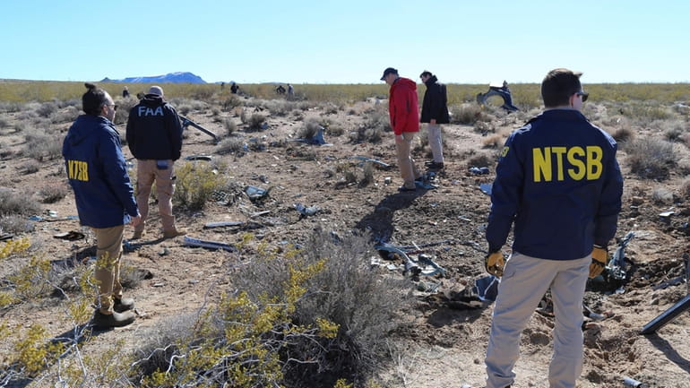 NTSB investigators survey the site of an Airbus Helicopters EC-130...