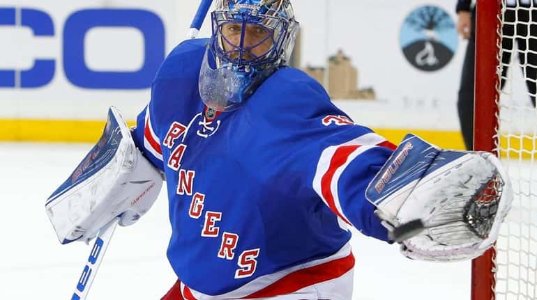 Henrik Lundqvist #30 of the New York Rangers makes a...