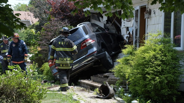 SUV after it hit the second house Friday in West Babylon. 