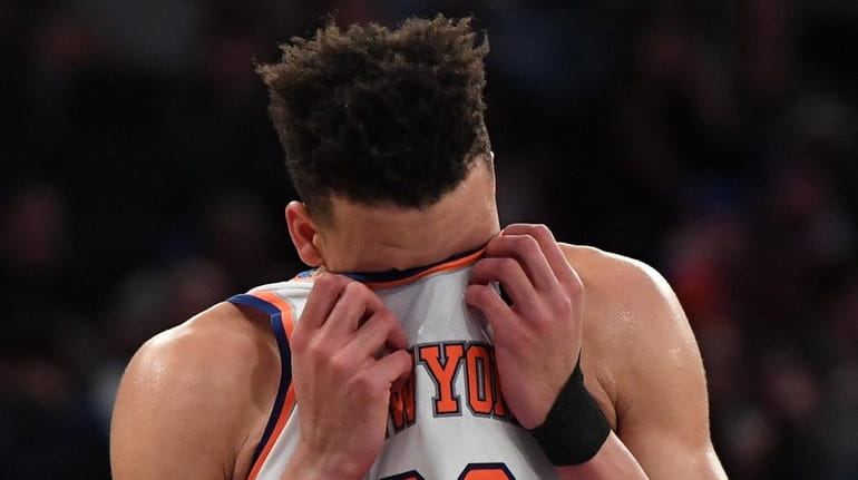 Knicks forward Kevin Knox wipes the sweat from his face...