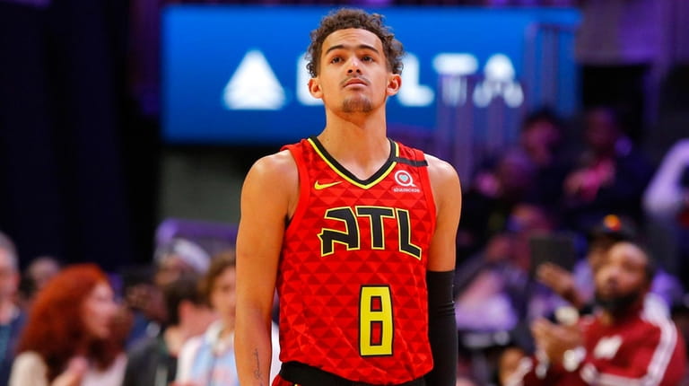 Hawks guard Trae Young wears a No. 8 jersey honoring...