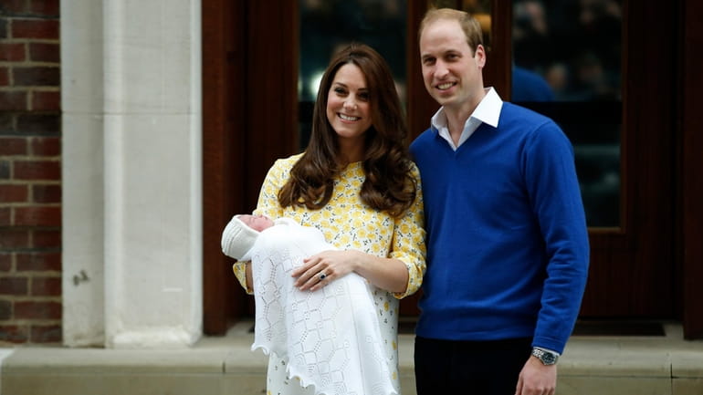 Britain's Prince William, right, and Kate, Duchess of Cambridge, hold...