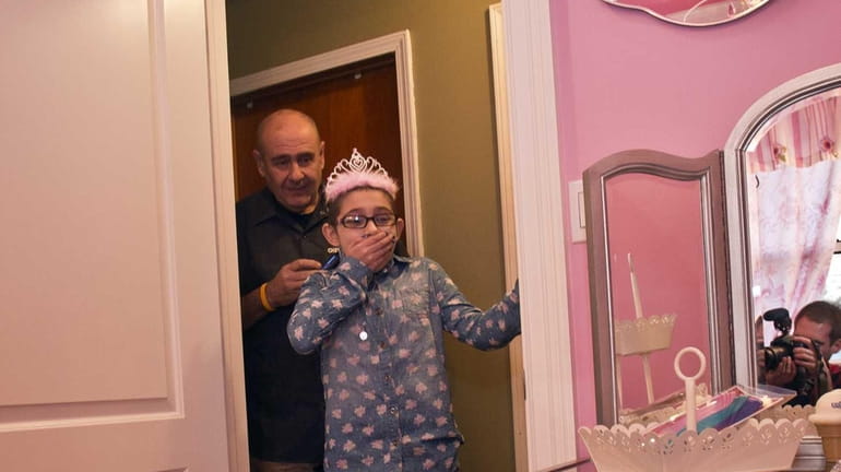 9-year-old Paula DeZotti reacts as she sees her new Princess...