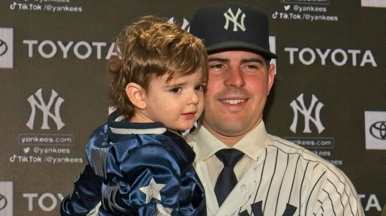 New Yankees pitcher Carlos Rodón and his son Bo at...