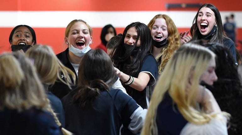 St. Anthony's girls bowling teammates celebrate after their win over...