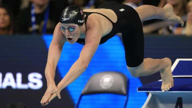 Missy Franklin dives at the start of her heat in...