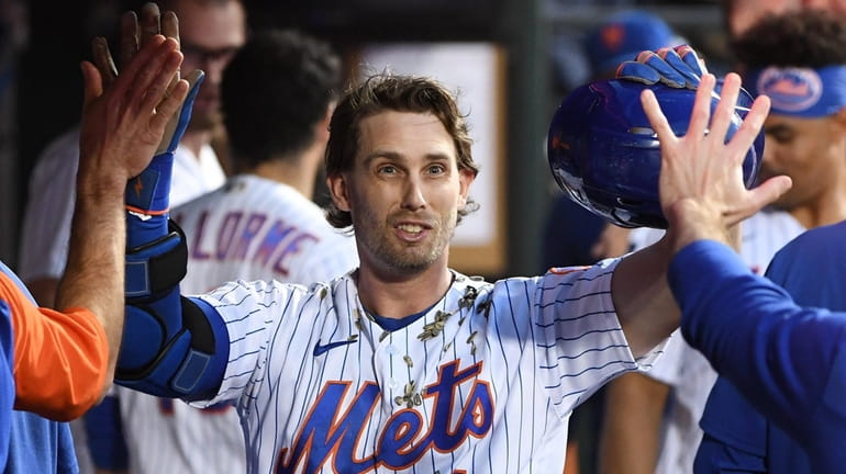 New York Mets' Jeff McNeil in the dugout after his...