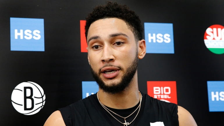 Nets guard Ben Simmons answers questions from reporters during practice at...