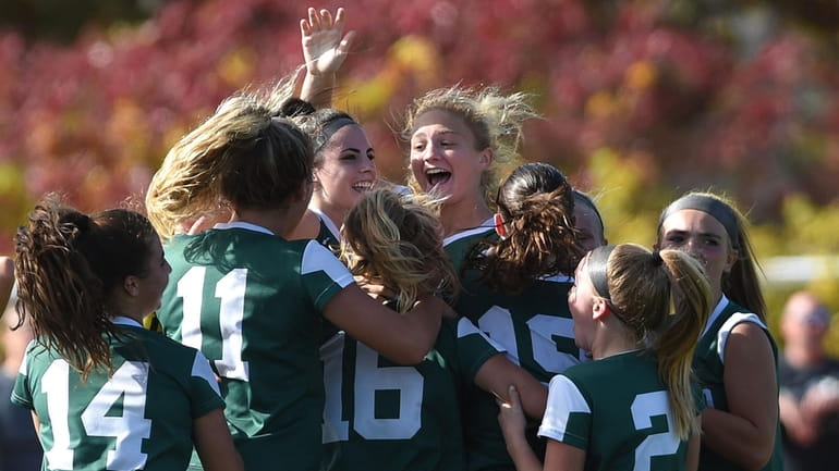 Seaford girls soccer teammates celebrate after their 1-0 overtime win...