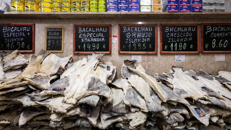 Slabs of dried, salted codfish stacked at a stall in...