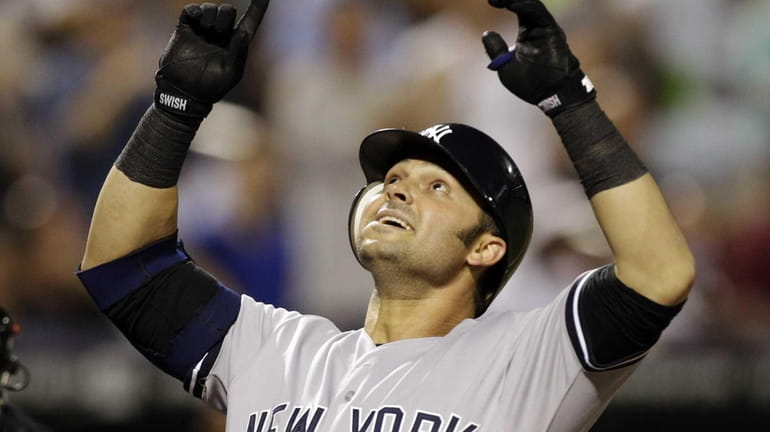New York Yankees' Nick Swisher reacts at the plate after...