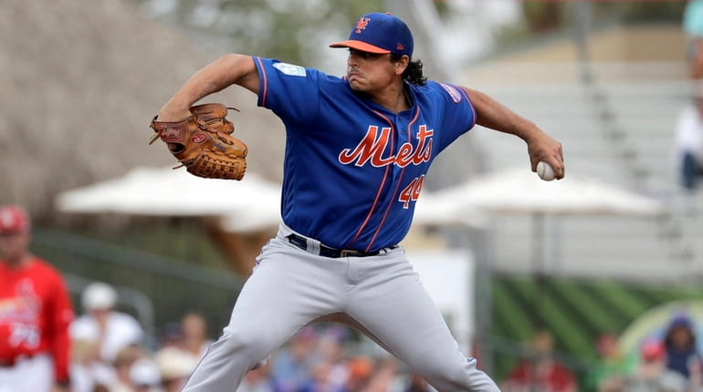 Mets starting pitcher Jason Vargas throws during the first inning...