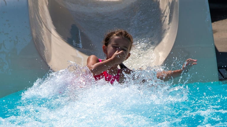 Emma Williams of North Merrick, cools off on the waterslide...