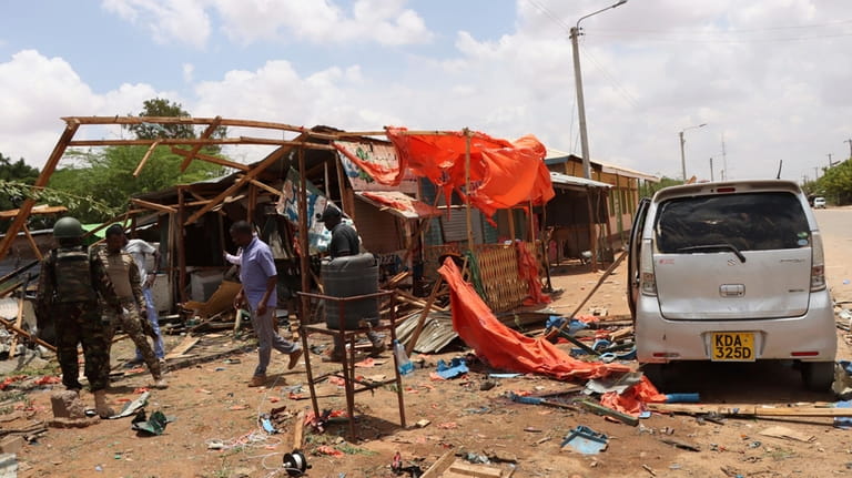 Kenyan armed soldiers are seen after an explosion at a...