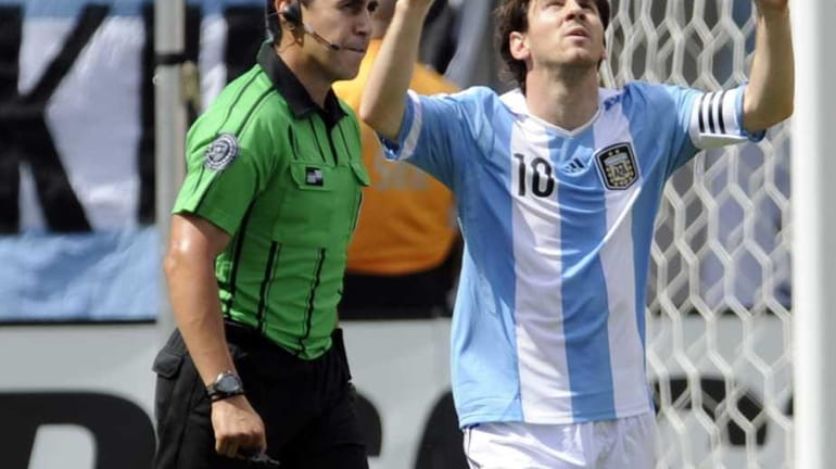 Argentina's Lionel Messi celebrates his goal as referee Jair Marrufo,...
