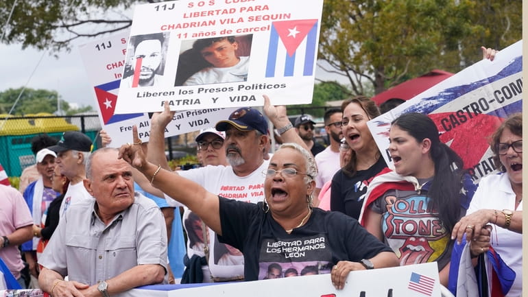 Cuban Americans protest the Cuba national baseball team playing at...