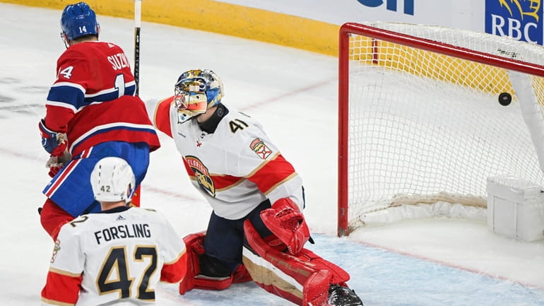 Montreal Canadiens' Nick Suzuki (14) scores against Florida Panthers goaltender...