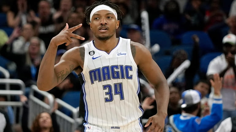 Orlando Magic's Wendell Carter Jr. (34) holds out three fingers...
