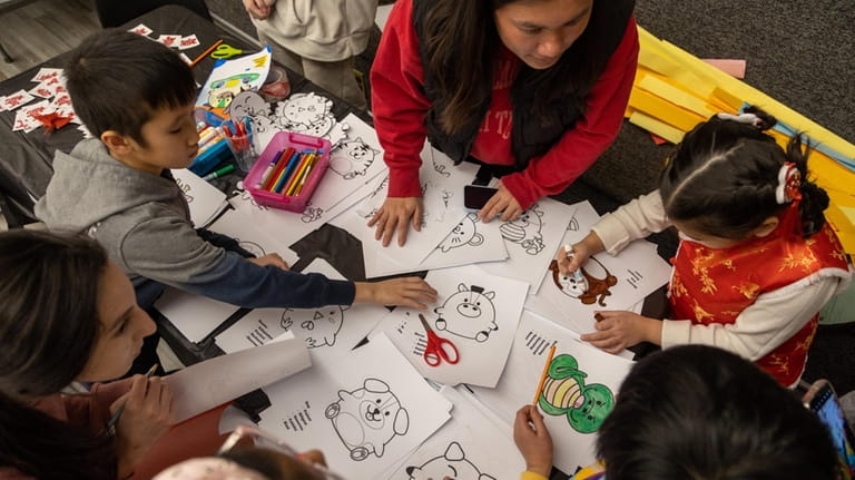 Children take part in arts and crafts at the festival Monday...
