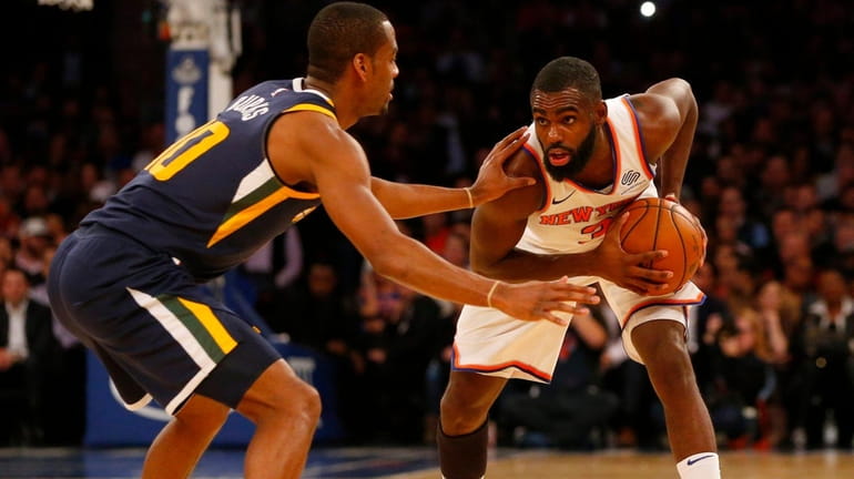 Tim Hardaway Jr. of the Knicks controls the ball against...
