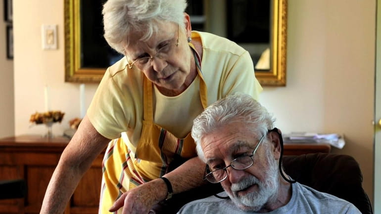 Harriet Garzero and her husband, Edward, who has Alzheimer's, take...