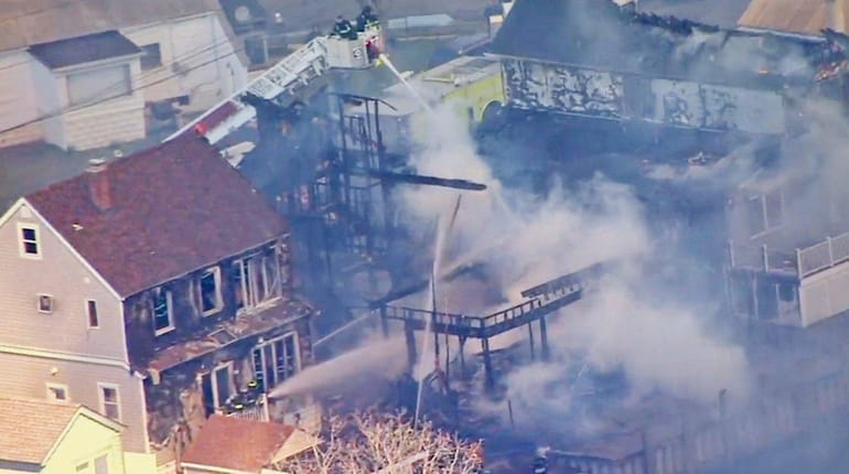 Firefighters battled a fire that spread to five homes in...