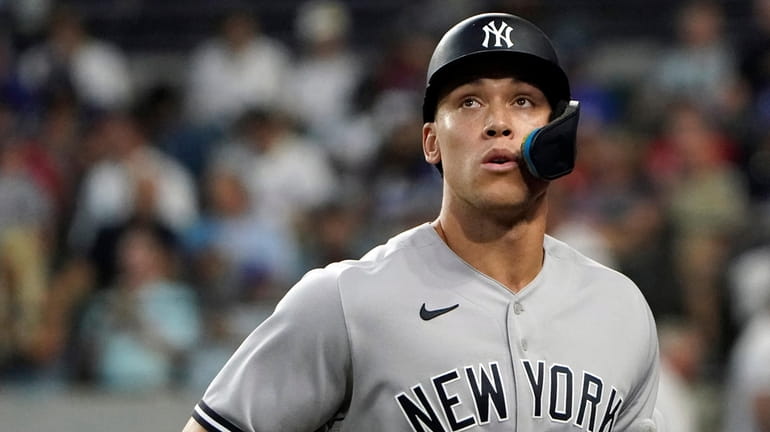 New York Yankees' Aaron Judge heads to the dugout after...