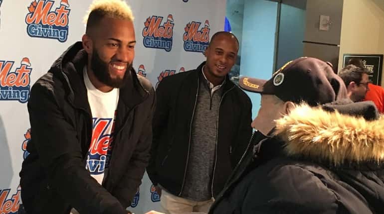 Mets shortstop Amed Rosario greets a fan who donated to...