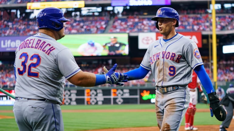 The Mets' Brandon Nimmo, right, celebrates after his run with...