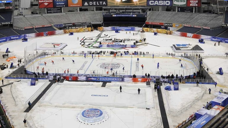 The New York Islanders practice on the ice at Yankee...