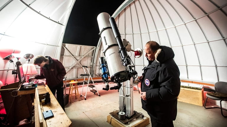 Chuck Cardona sets up the 10-inch Zerochromat refracting telescope before...