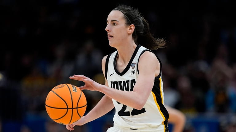 Iowa guard Caitlin Clark drives up court during the first...